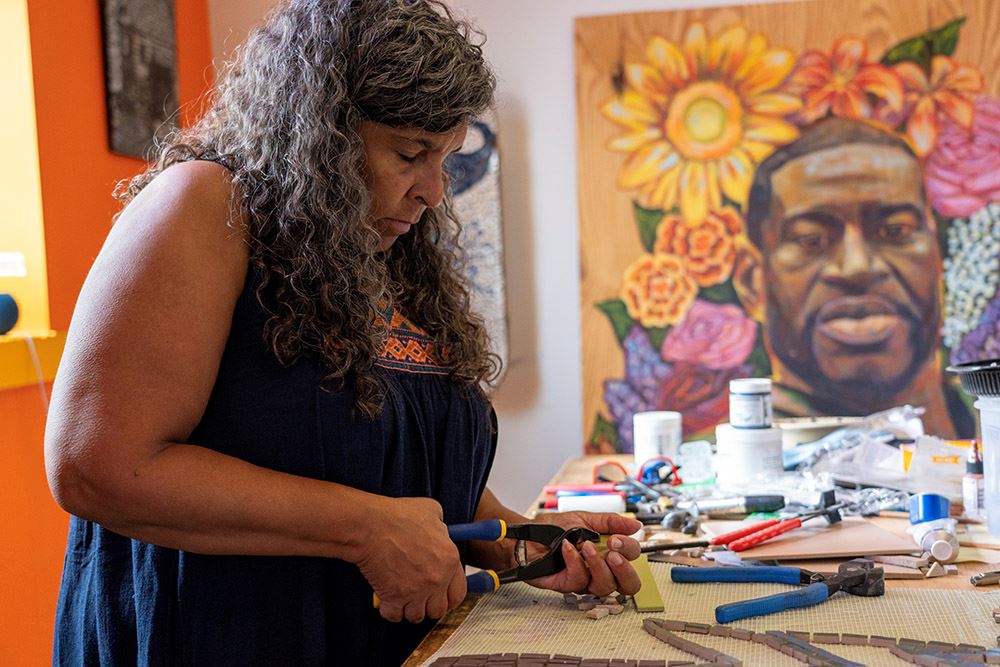 Mosaic artist Lori Greene works on her newest installation for Harriet Alexander Nature Center.