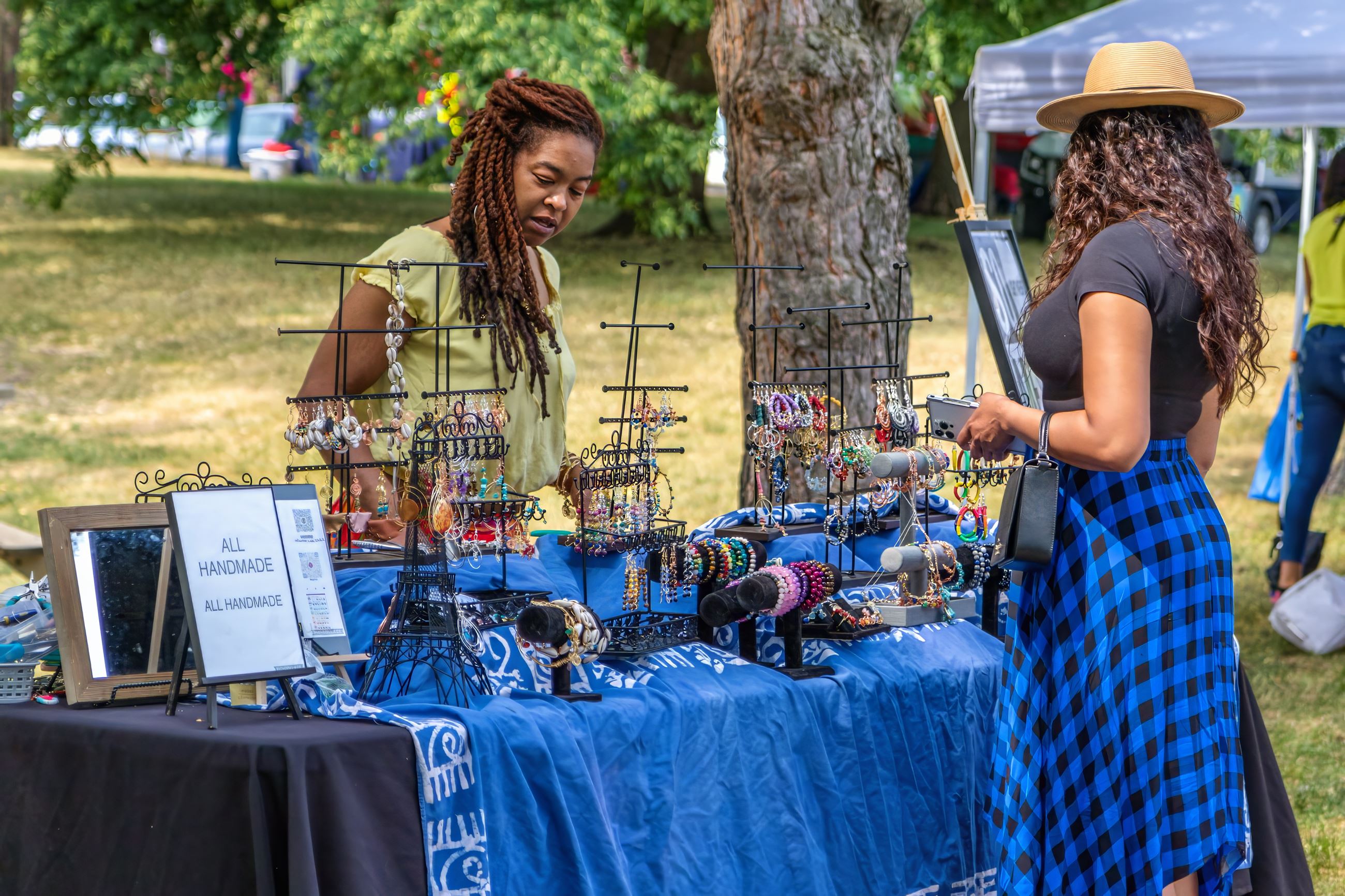 A woman browses crafted goods at Juneteenth.